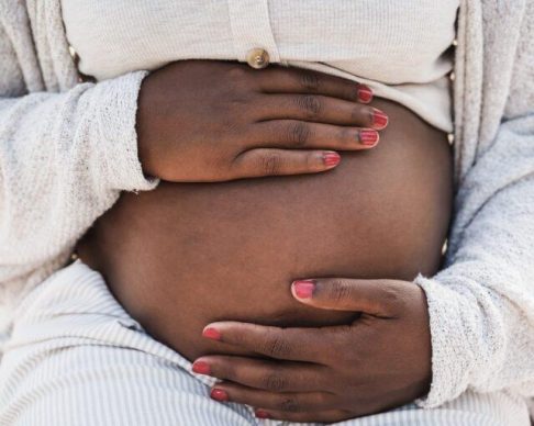 Close,Up,Of,African,Pregnant,Woman,Holding,Her,Belly,-